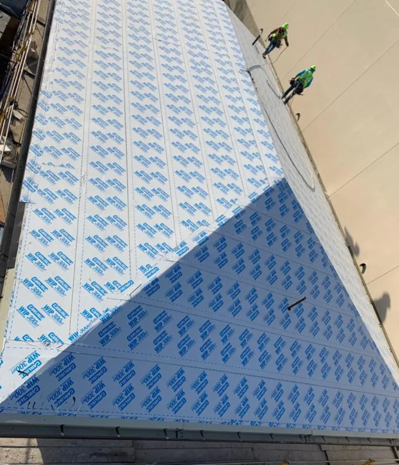 Professional roofers installing underlayment on a metal roof in West Hazleton